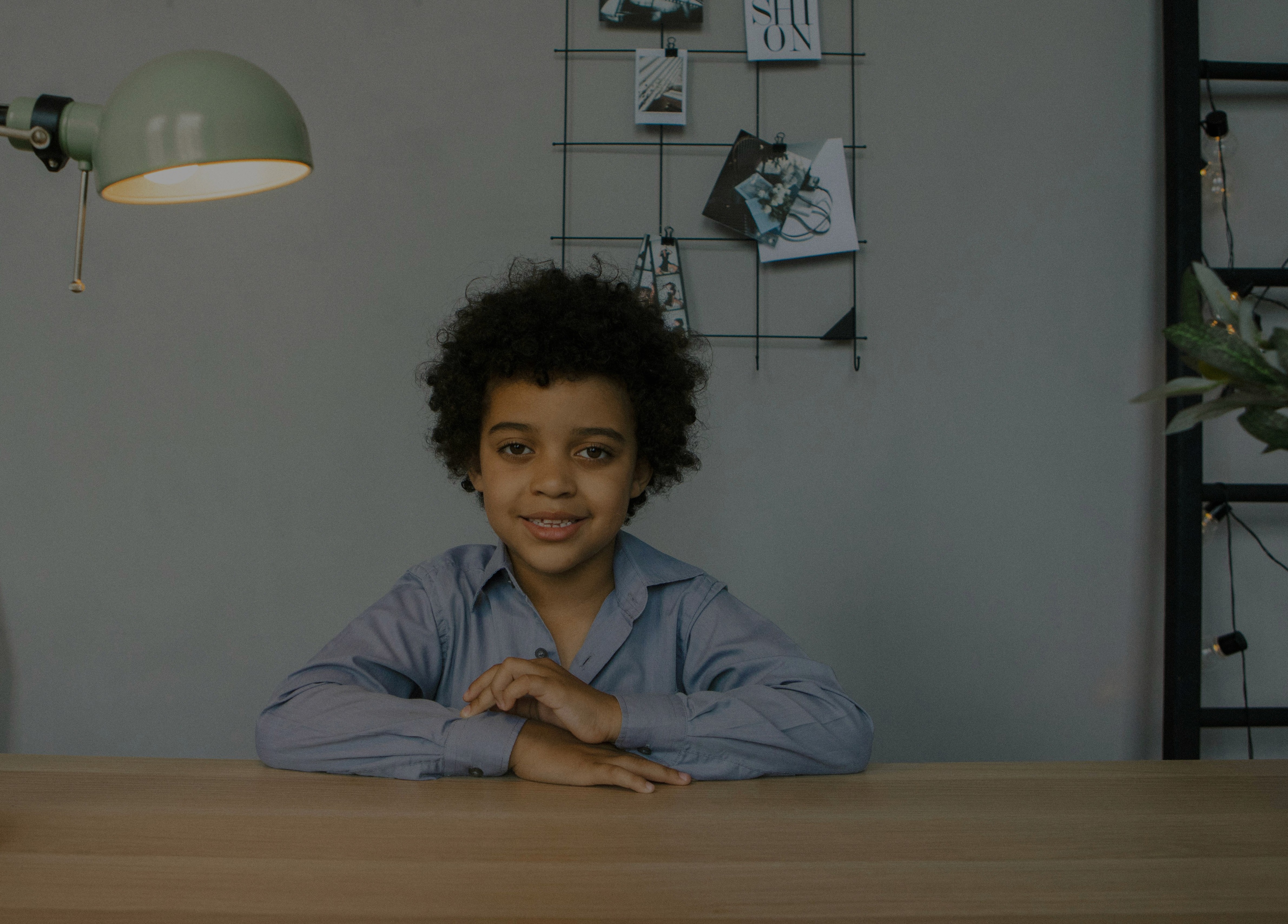 A young child sitting calmly at a desk, representing hope and confidence for children managing tics with CBIT treatment.