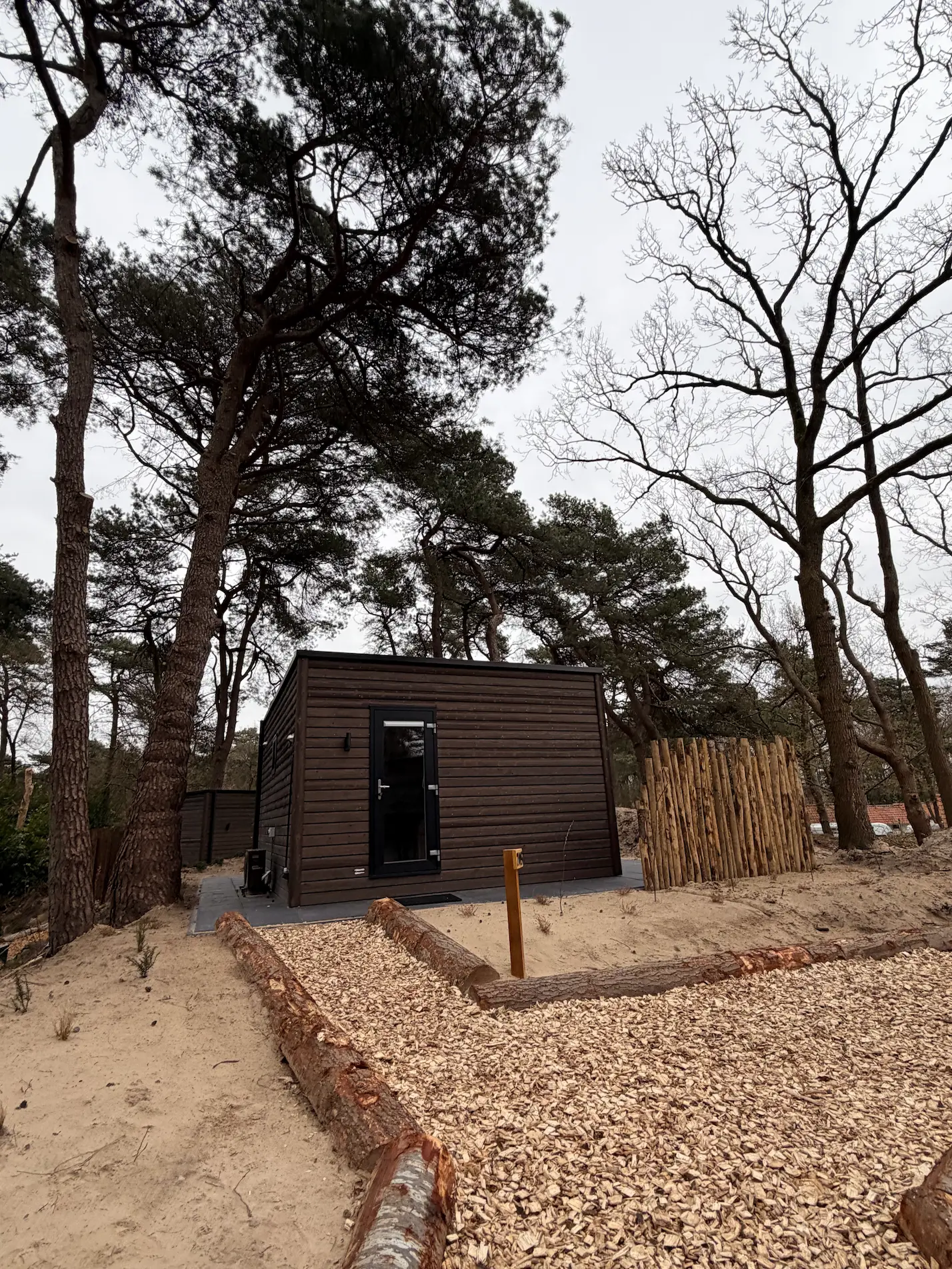 a wooden walkway between two buildings with windows