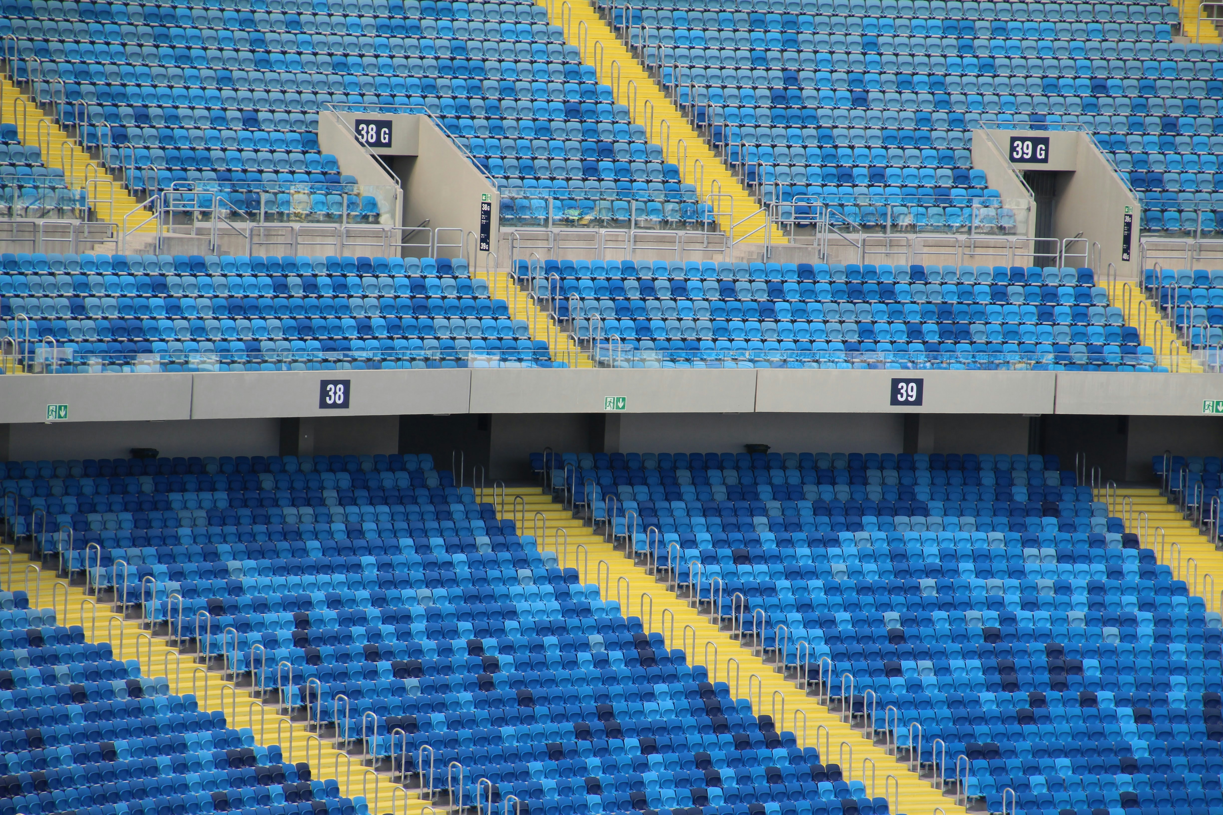 Empty blue stadium seats with yellow accents