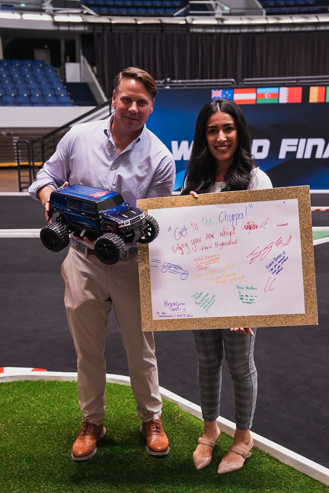 Conyers Davis and Francisca Martinez of the USC Schwarzenegger Institute holding Arnold Schwarzenegger’s new gift, a 1:10 scale model of Schwarzenegger’s infamous H2 Hummer