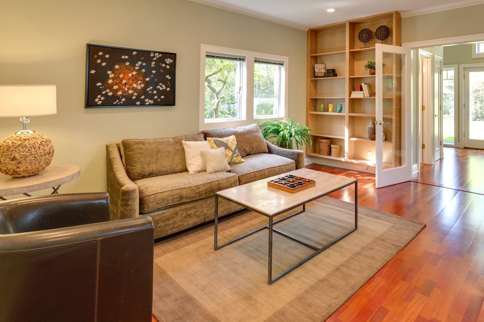 Warm contemporary living room with a bookshelf and glazed interior doors
