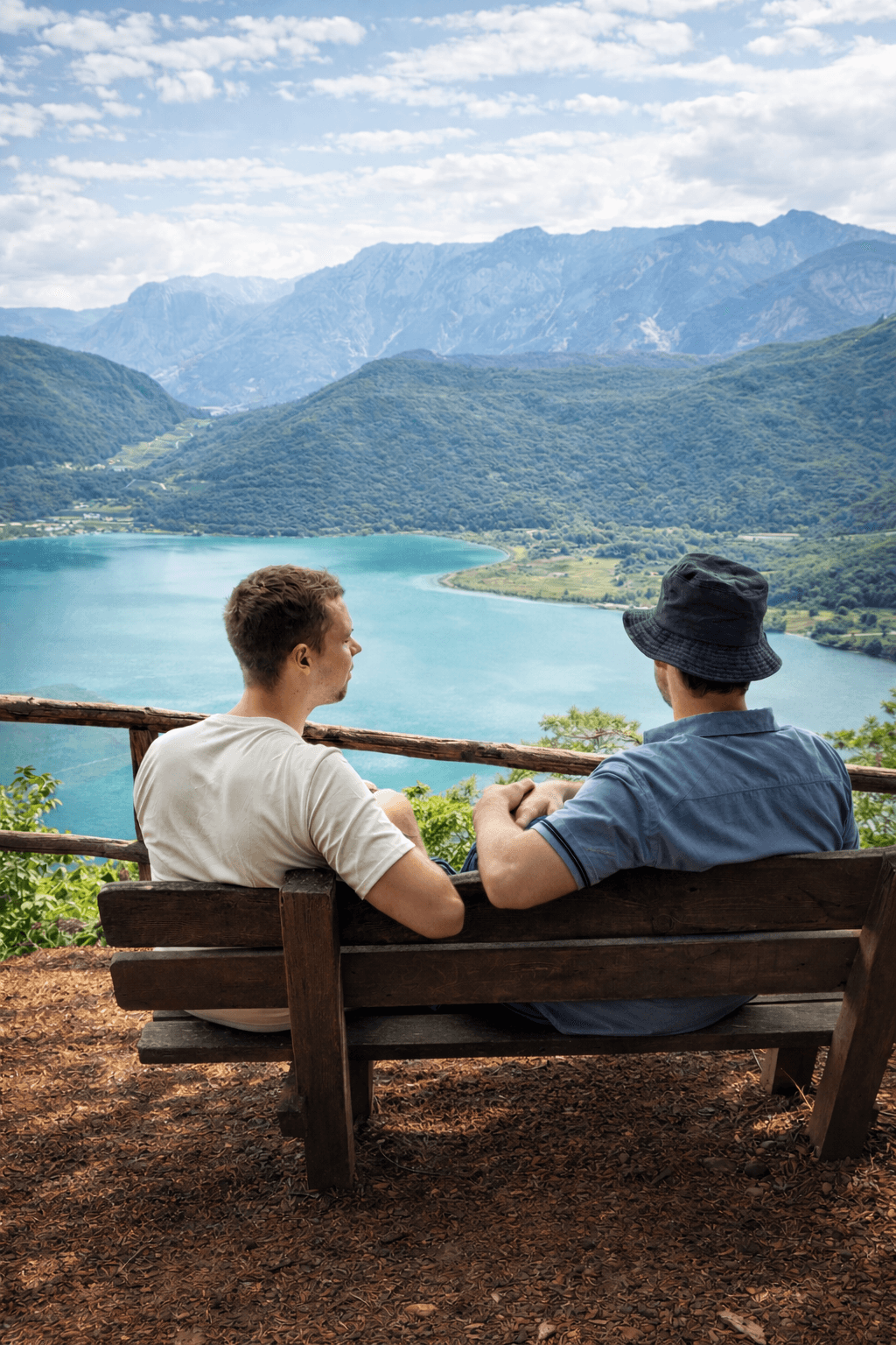 A young person with long, wavy hair sits in front of a plain background, looking directly at the camera.