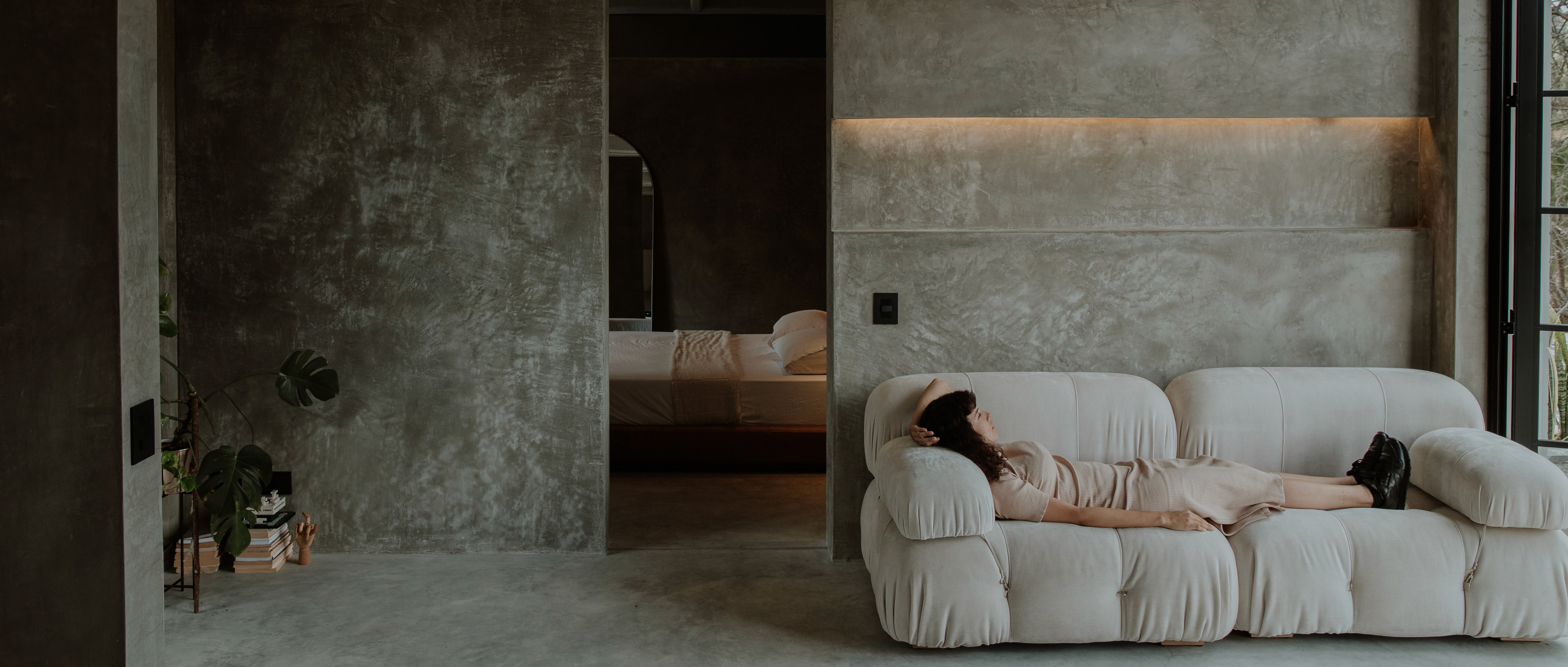 Double-height interior with flowing sculptural forms and warm raking light