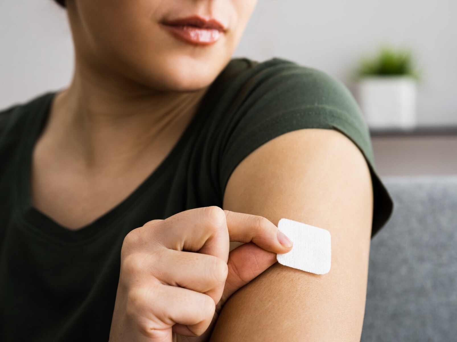 woman applying a birth control patch instead of using a weight gain birth control pill