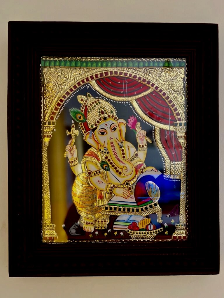 A Thanjavur Painting of Lord Ganesha with the use gold foil and gems in it.