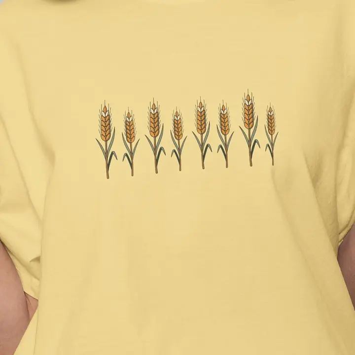 Painted wheat stalks printed on a butter-yellow tee
