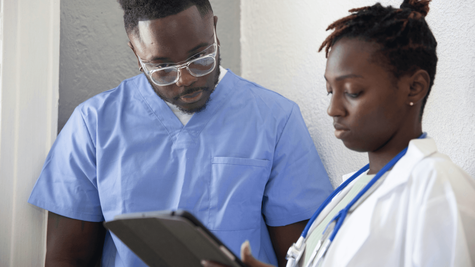 Two medical professionals looking at a tablet