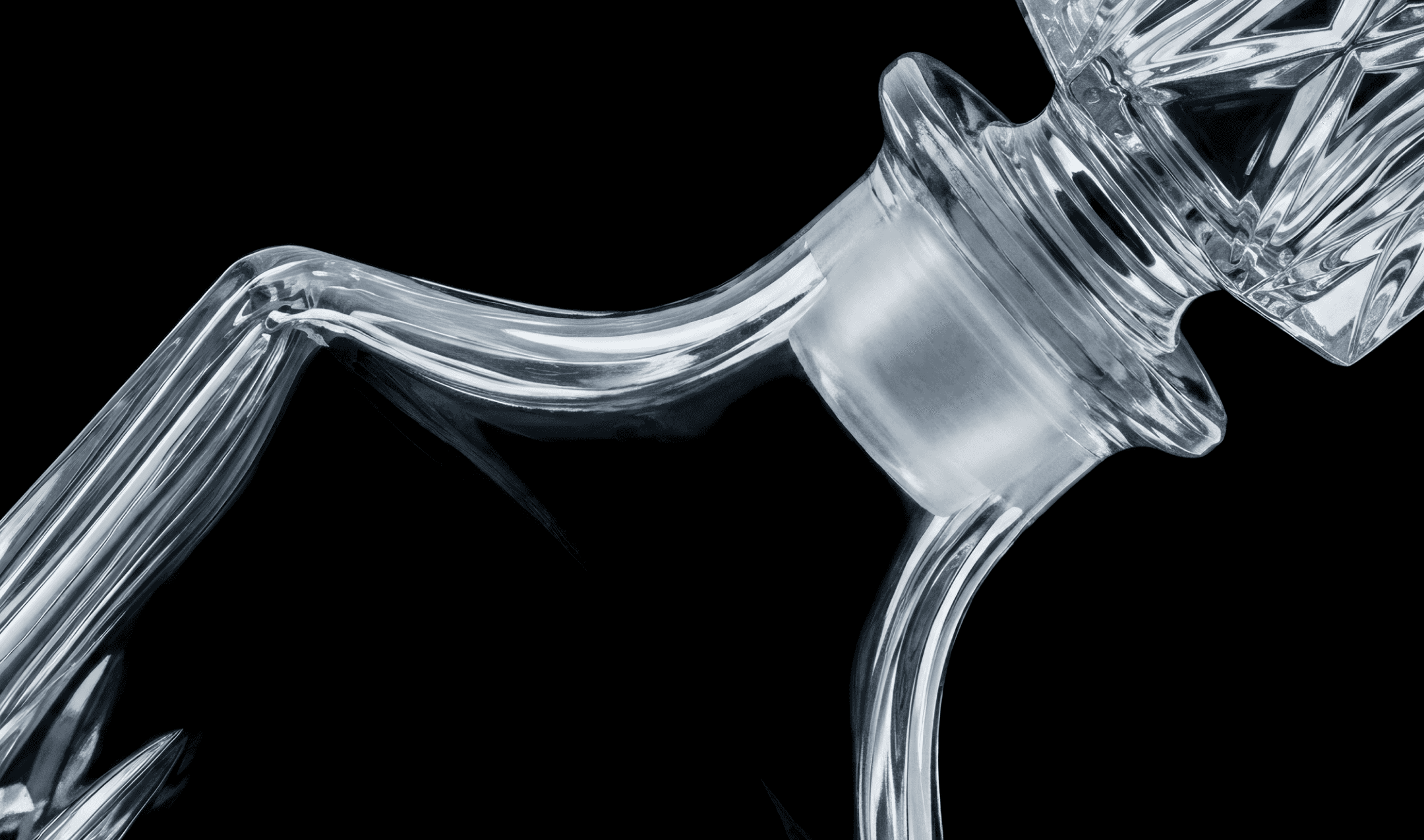 A glass liquor bottle on a black background