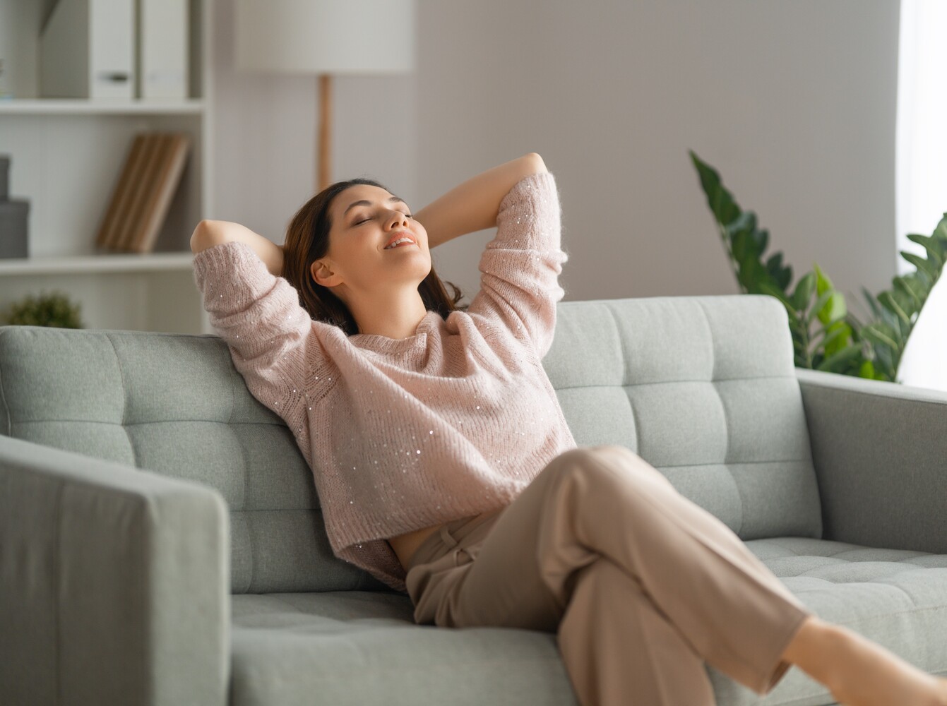 woman resting on her couch at home as part of her exercise bike weight loss plan