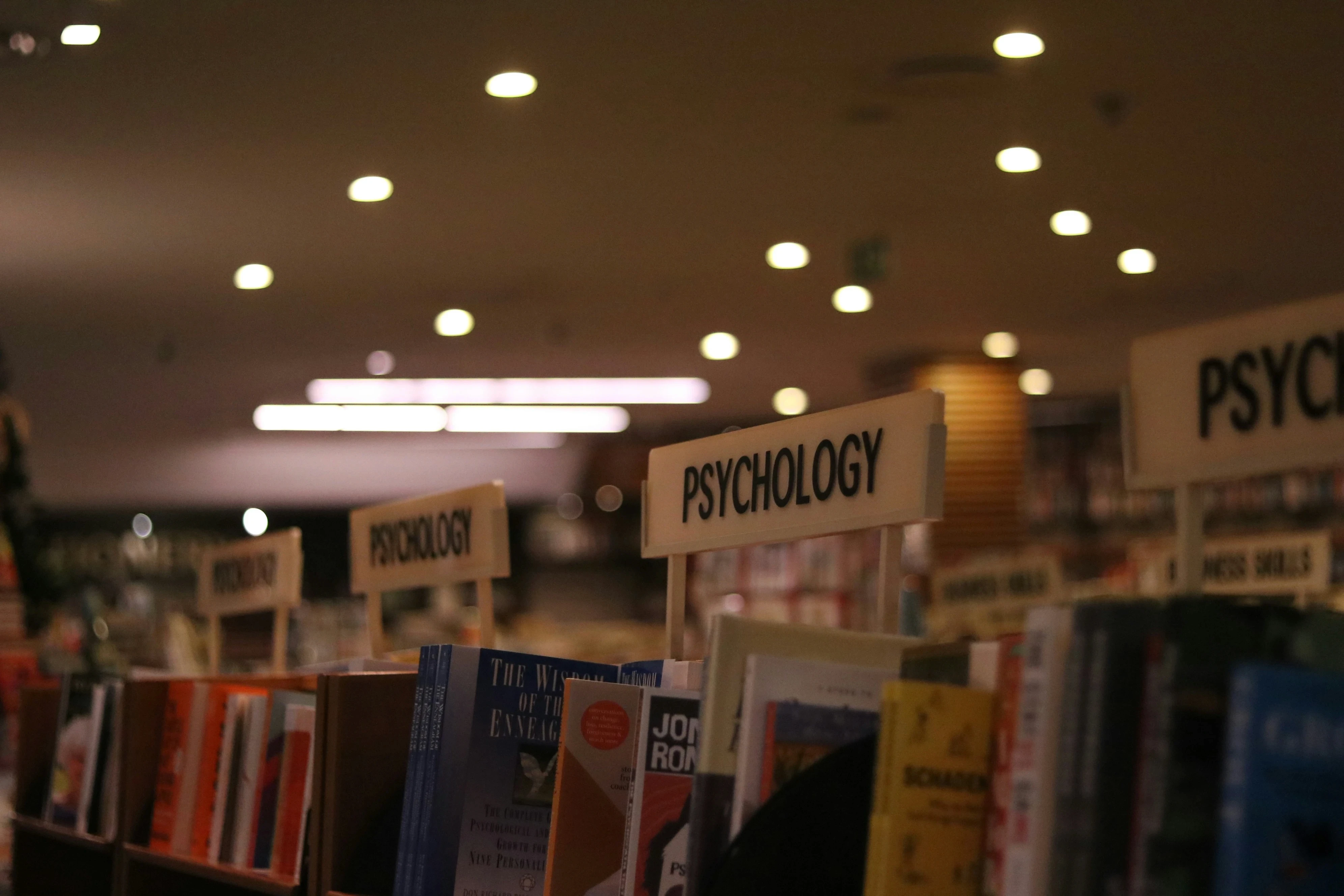 Close-up of psychology book section in a library or bookstore, ideal for high school students exploring RISE Research, STEM, or summer programs in psychology.