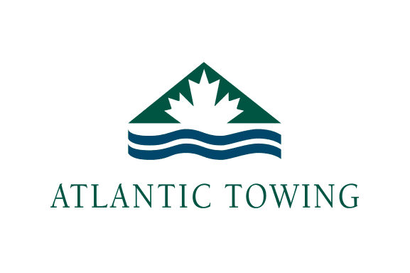 Logo of Atlantic Towing featuring a mountain and wave design with the company name below.