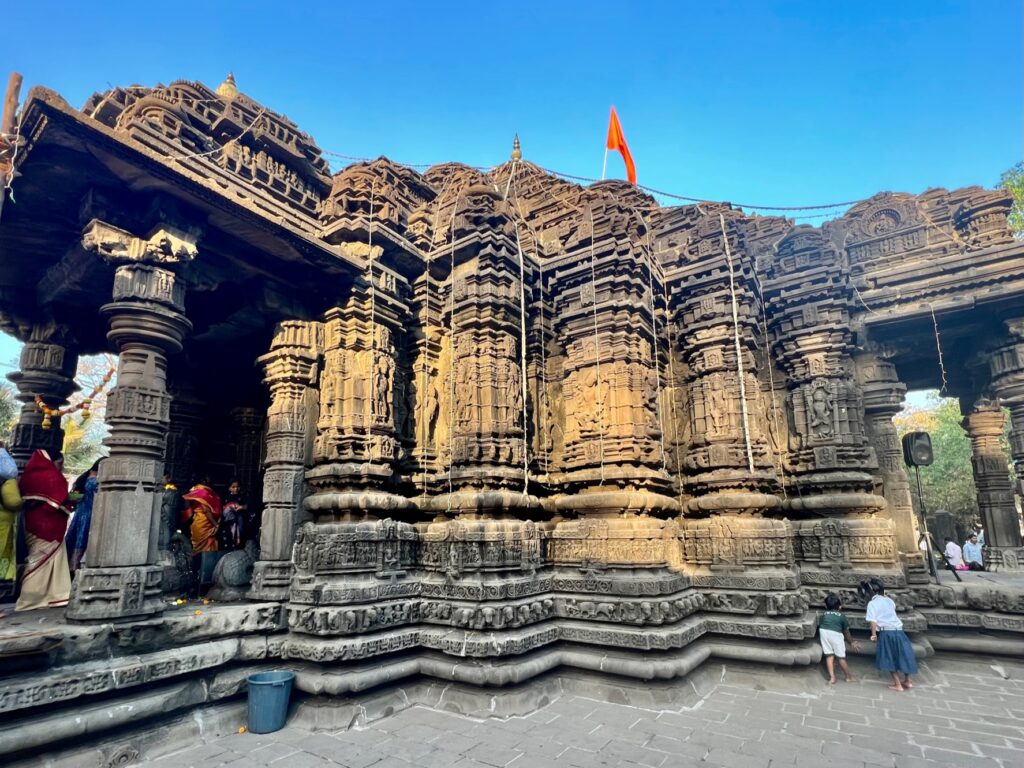 The exterior of the Shiv temple at Ambernath with fluted walls and numerous carvings.