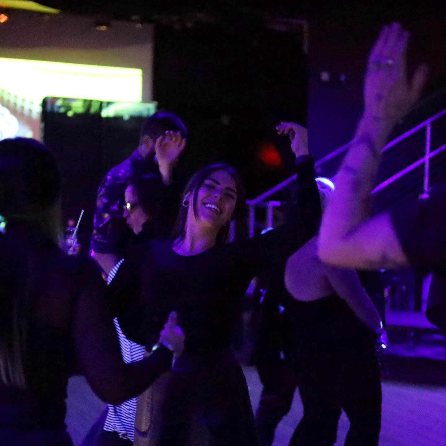Dancers in a purple-lit club