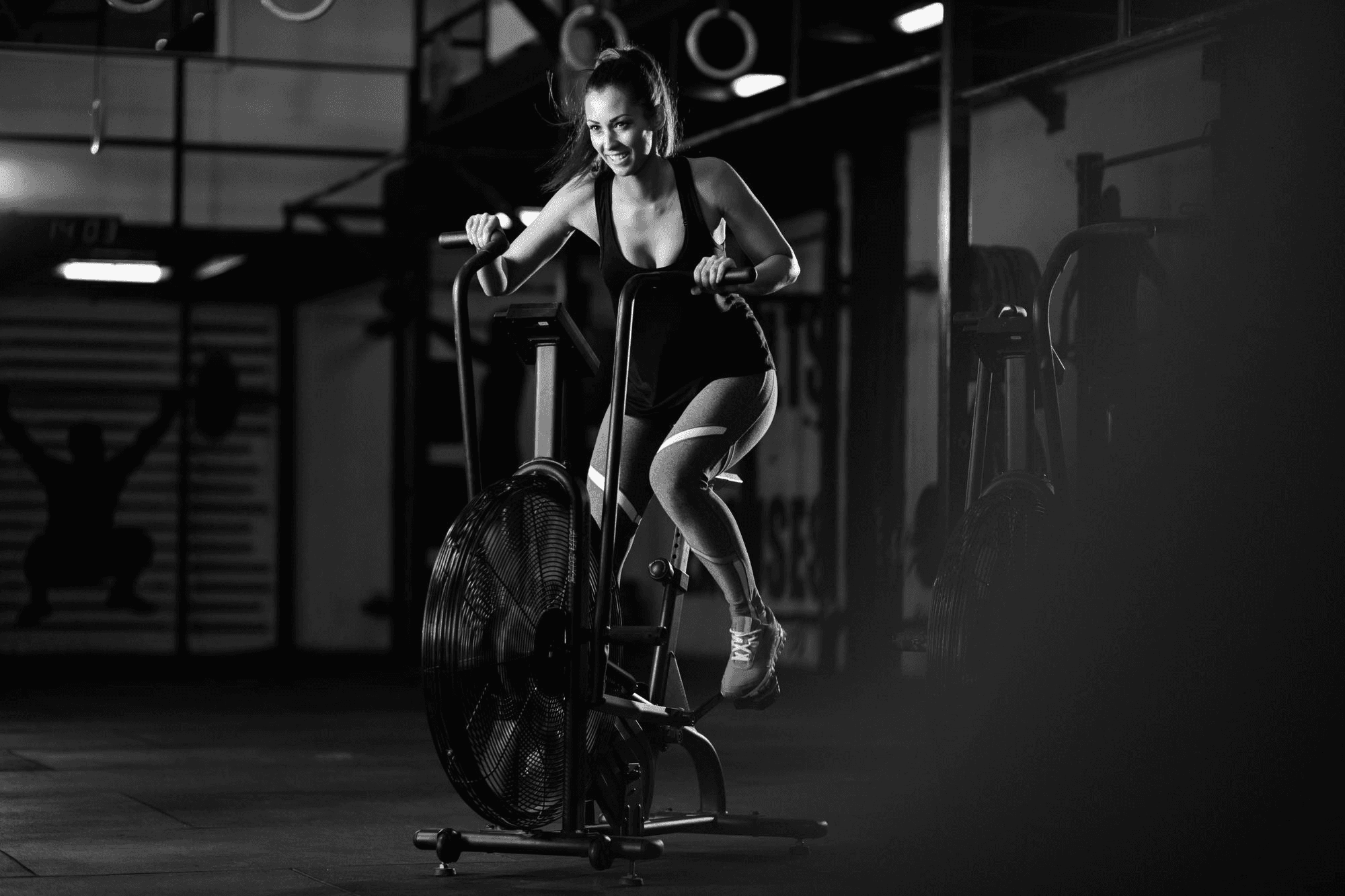 Woman doing indoor cycling workout in gym