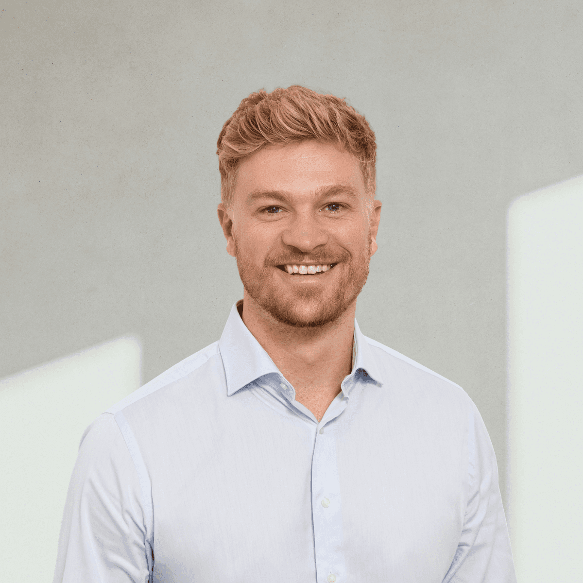 Close-up of a dark green leaf showing its textured surface and central vein against a muted background.