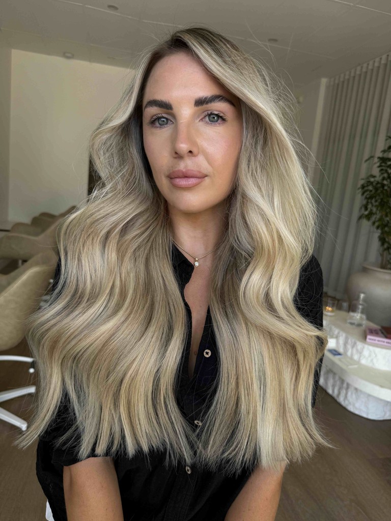 Model with rich, thick, blonde and brown hair done by Goldi