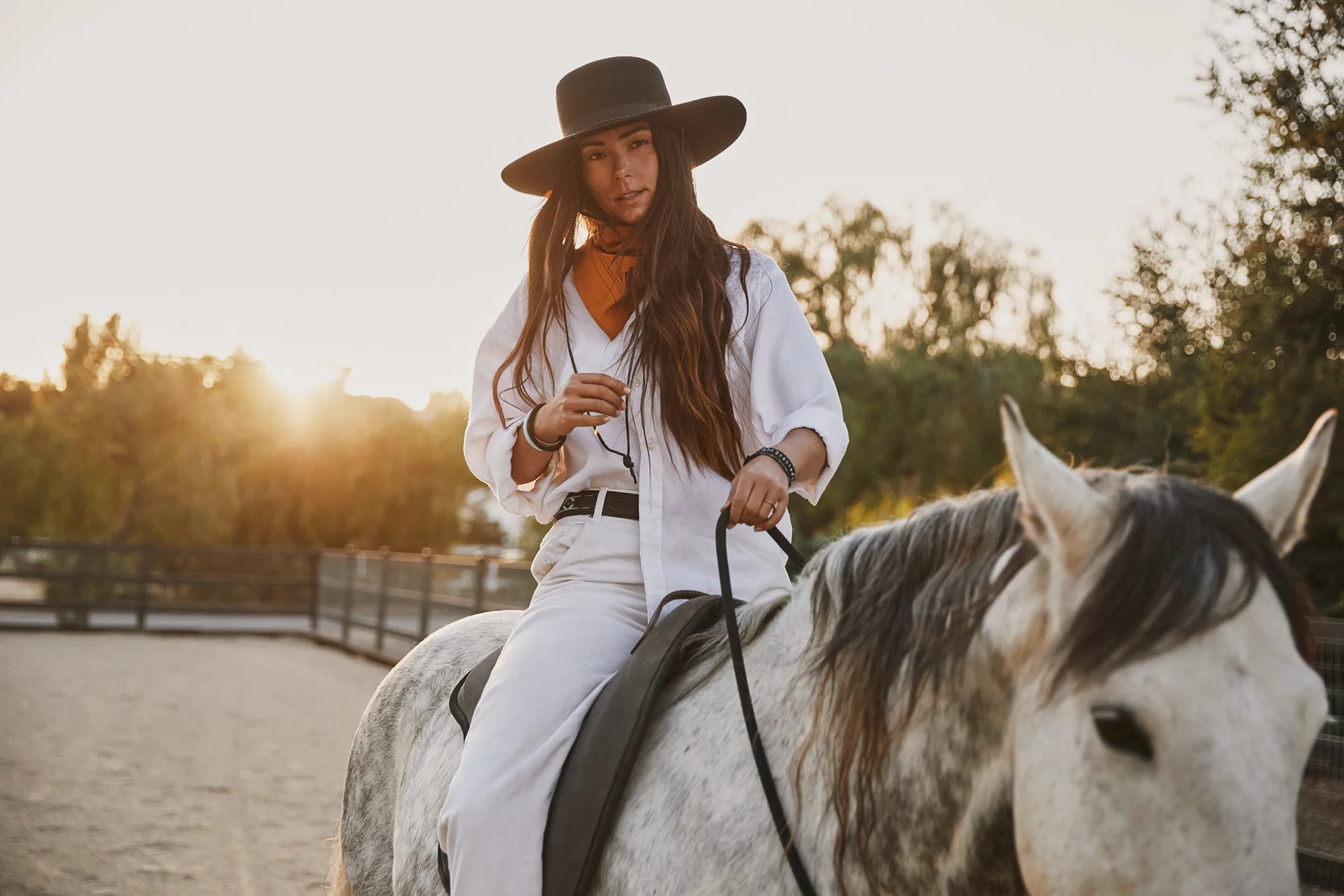 woman on gray horse holding reins at sunset — Alex Saidac photography by Tom Kubik