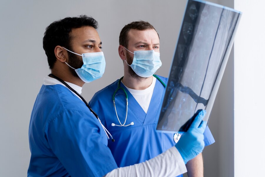 Two nurses viewing a radiation shot.