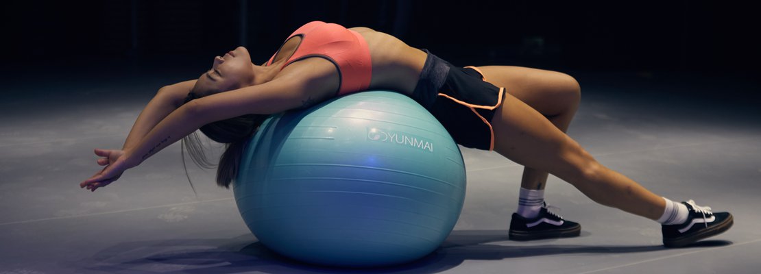  a woman laying on a yoga ball