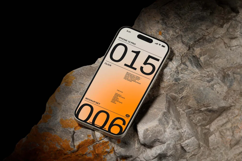iPhone 15 Pro mockup displayed on rugged, textured rock with an orange gradient screen design. The sleek phone contrasts sharply against the rough surface, creating a dynamic composition.