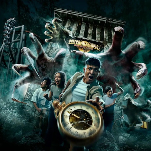 A frightened group of people run from giant hands near a Universal Studios building and rollercoaster, one holding a compass.