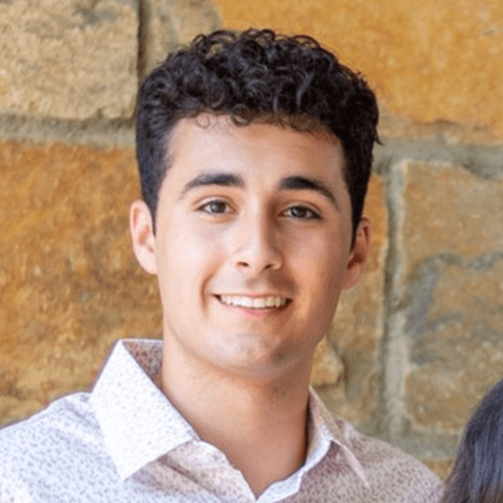 smiling woman wearing white and black pinstriped collared top