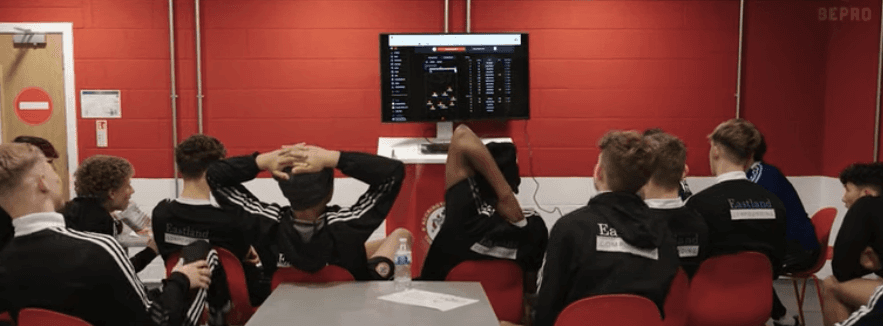 Accrington youth players looking at their stats on a screen