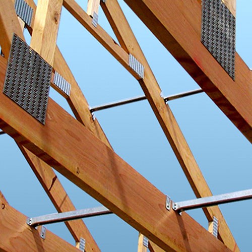 Flat-lay of curated material samples including stone tiles, textured fabrics, ceramics, and botanicals arranged on a neutral surface.