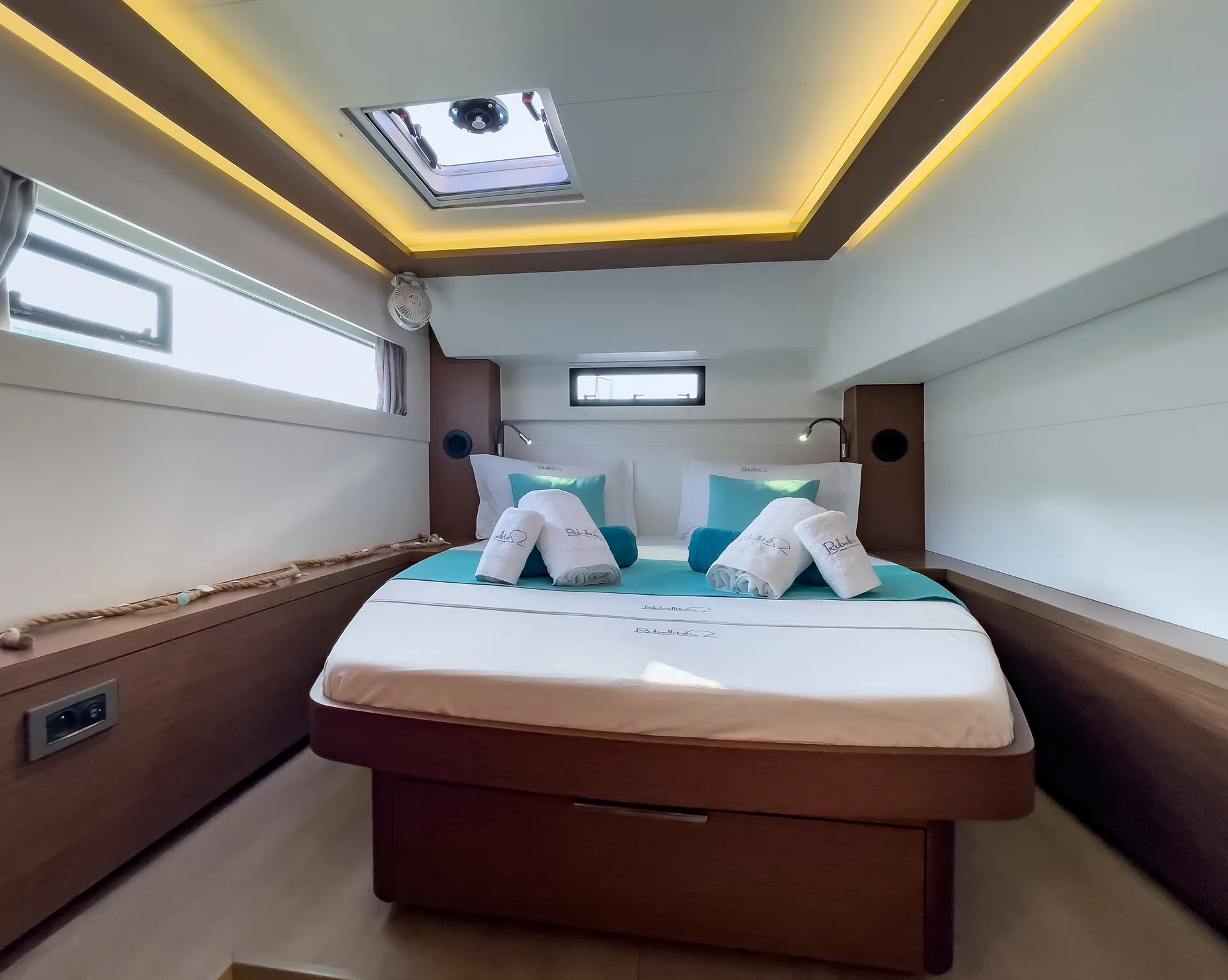 White Rock 36 speedboat with captain at helm cruising calm blue waters near Paros coastline with hills in background.