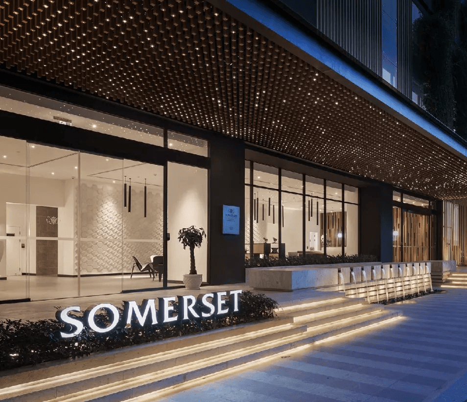 Ground-level entrance and porte-cochere featuring a rhythmic timber-slat ceiling, integrated starry-night LED lighting, and a linear water feature for a luxury arrival experience