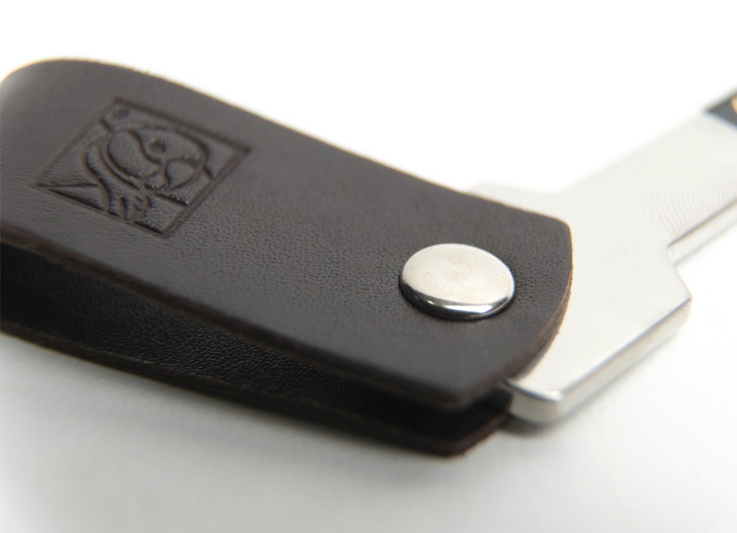 Close-up macro shot of the dark brown leather showing the silver rivet and the embossed square logo.