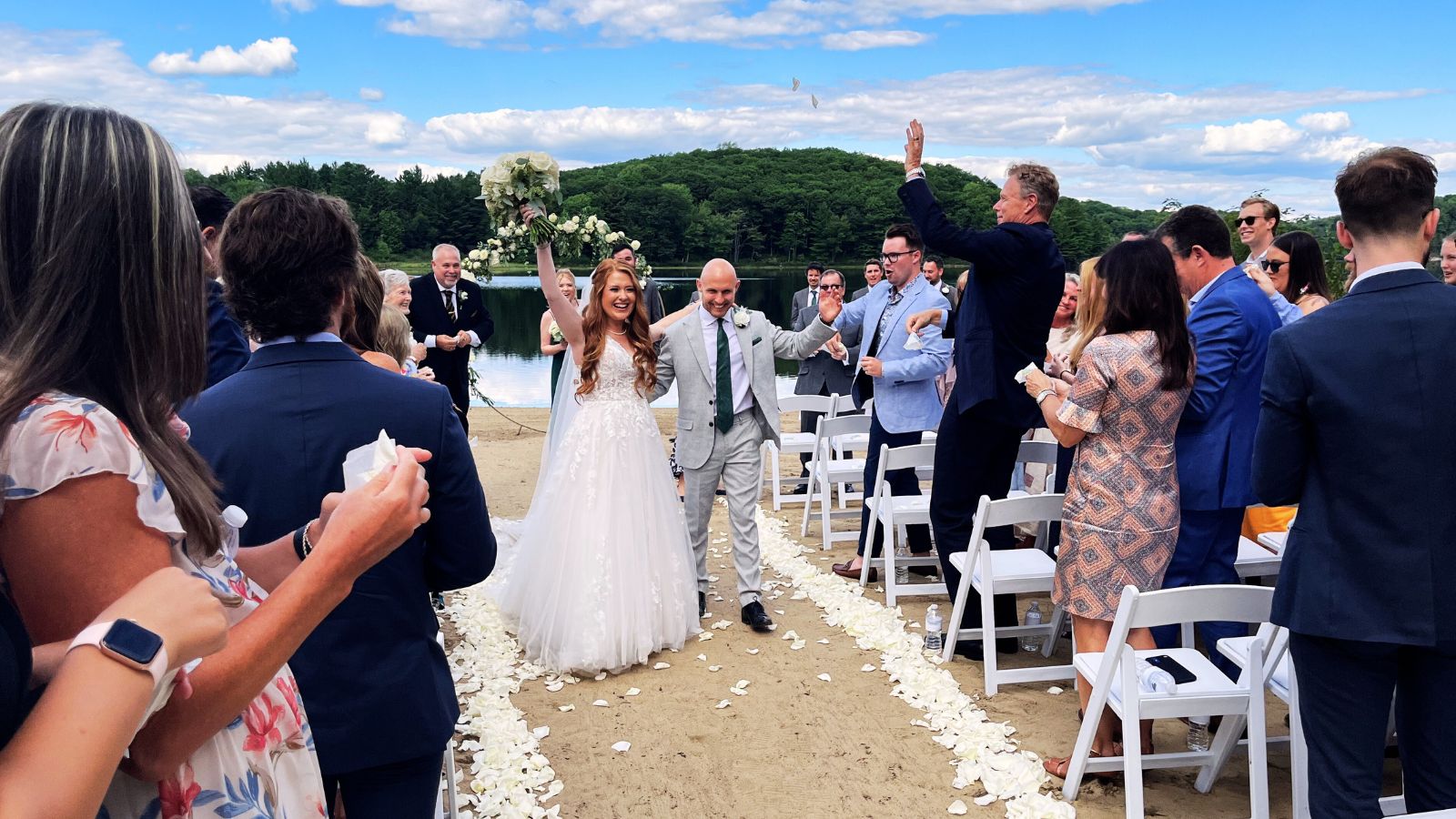 Bride and groom leaving their outdoor wedding ceremony.