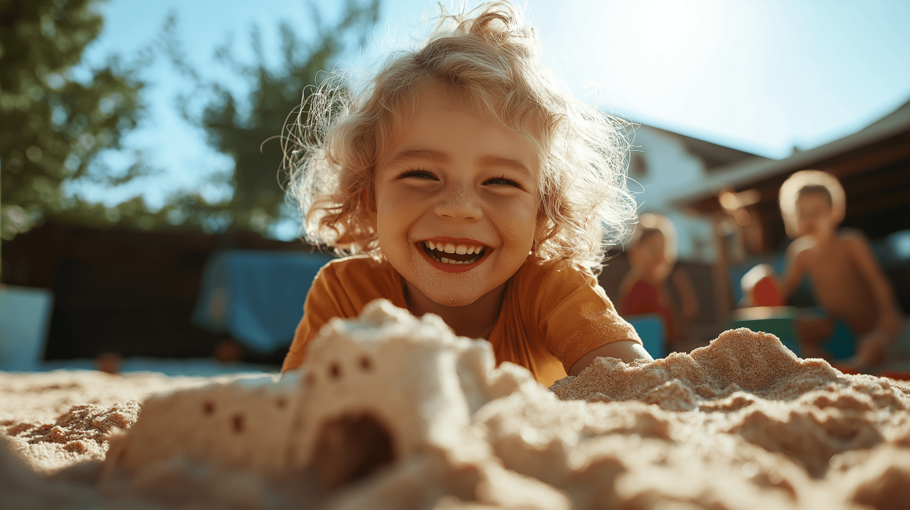 Nanny and children building sandcastles in a backyard play area