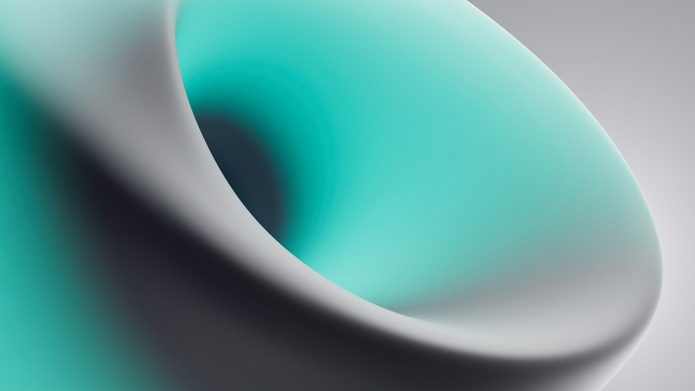 A winding road cuts through rocky terrain, surrounded by patches of green grass and illuminated by sunlight.