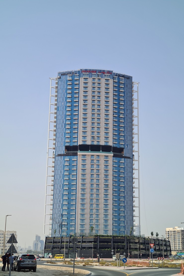 The impressive facade of Miraclz by Danube Properties. Expert property brokerage for luxury towers in Dubai.