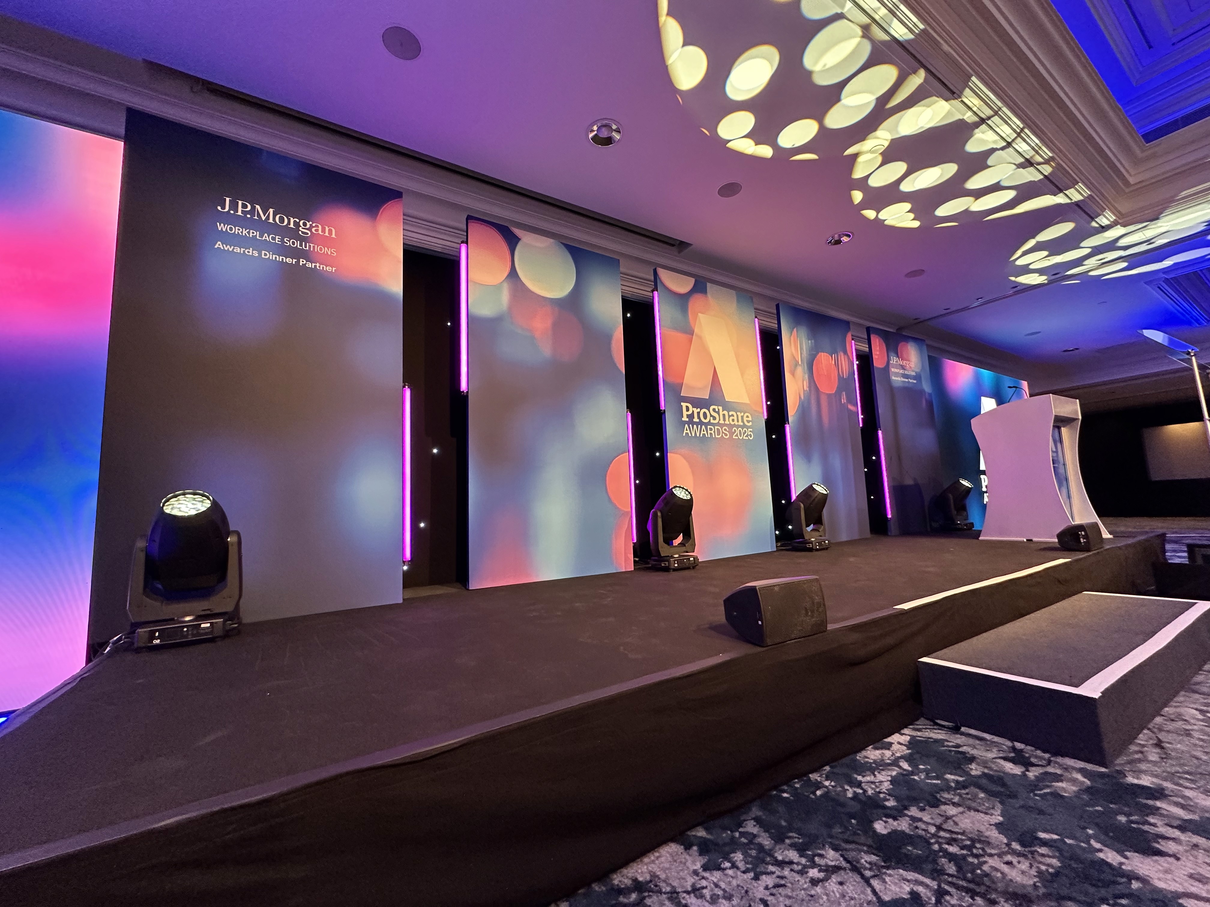ProShare Awards 2025 stage with printed scenic panels, lighting and branded event backdrop