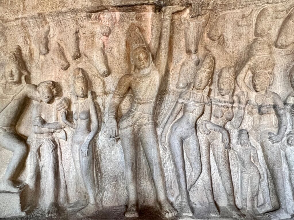 A rock-cut bas relief of Lord Krishan lifting Govardhan parvat using his little finger. The gopis and others ar looking in awe and ignorance.