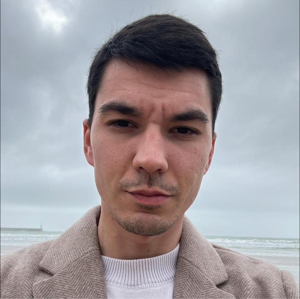 man in blue denim button up jacket standing on road during daytime