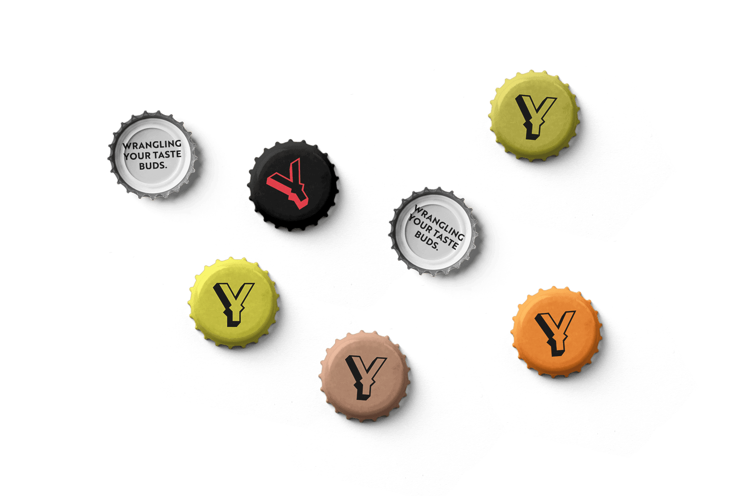 Green, black, orange, and brown YeeHop beer bottle caps, with lettermark branding on the outer casing and ‘wrangling your taste buds’ printed on the inside of each cap.