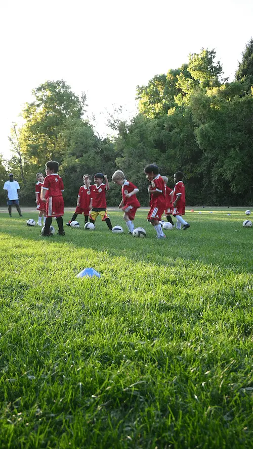 a young boy standing on a soccer field