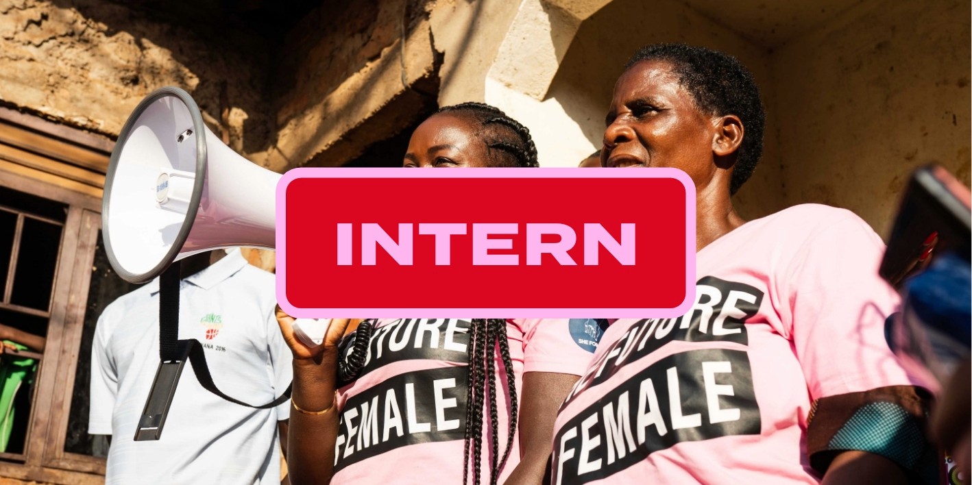 Person walks under a large modern building overhang.