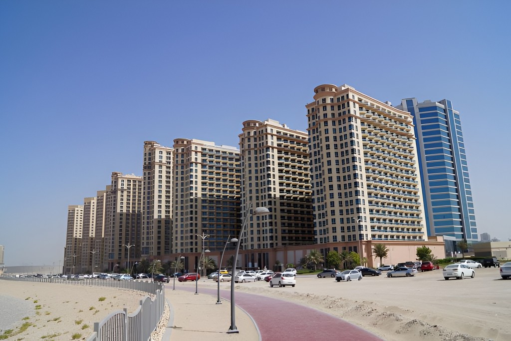 An empty roadway with towering buildings in the distance, prominently showcasing Lakeside Tower.