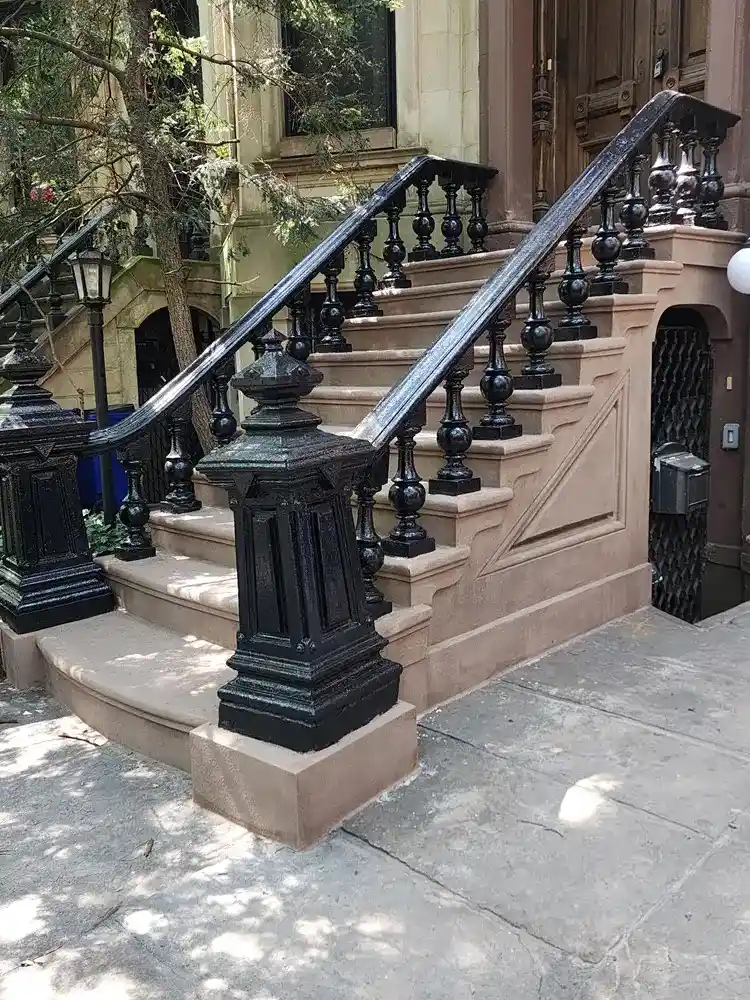 Restored historic brownstone stoop featuring detailed sandstone masonry repair in Park Slope, Brooklyn, NYC