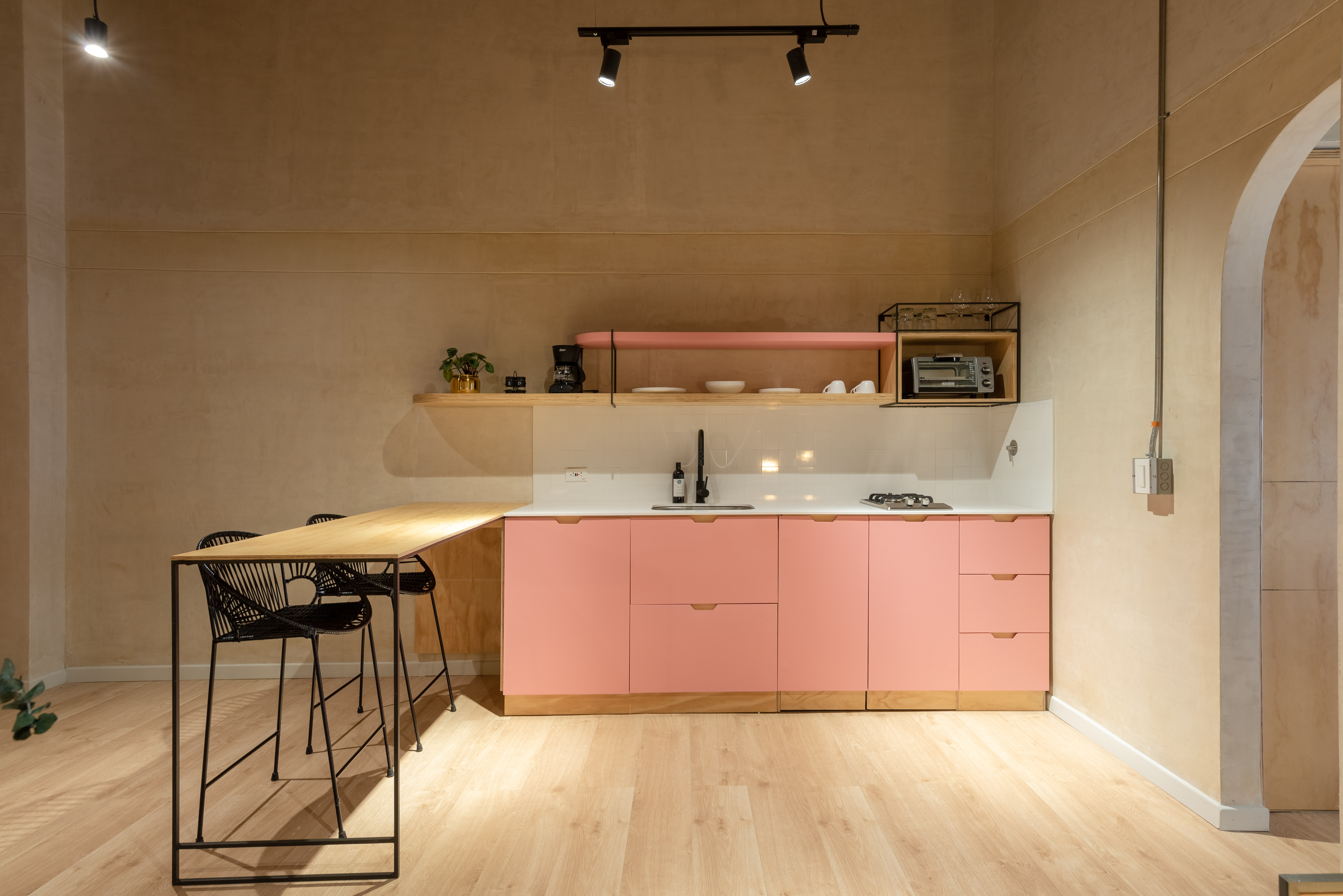 Double-height interior with flowing sculptural forms and warm raking light