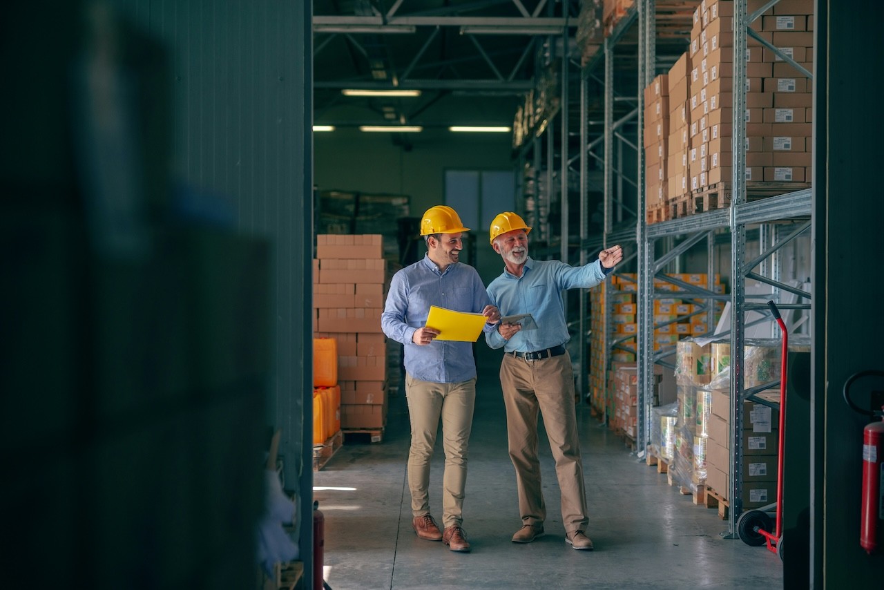 A SME Owner standing in his production facility smiling
