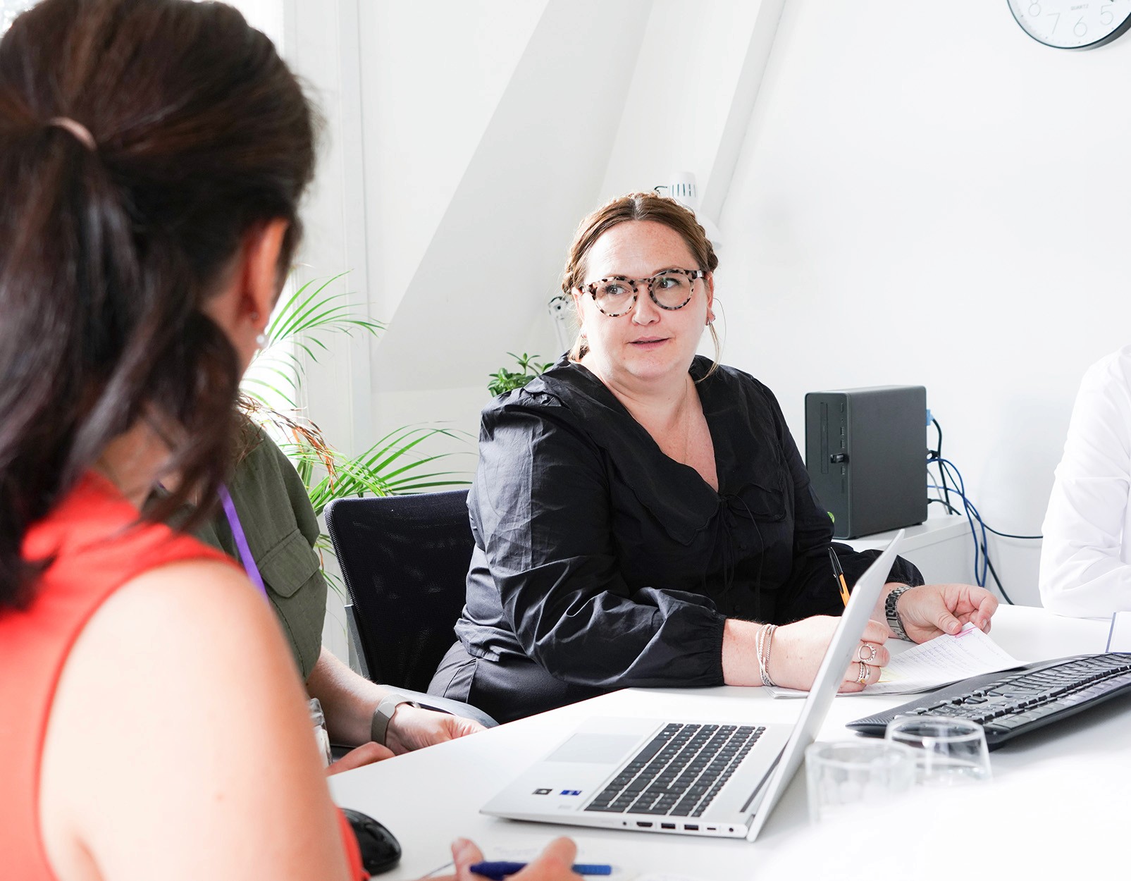 Hughes Price Walker team discussing investment advice and pension scheme strategy in a meeting.