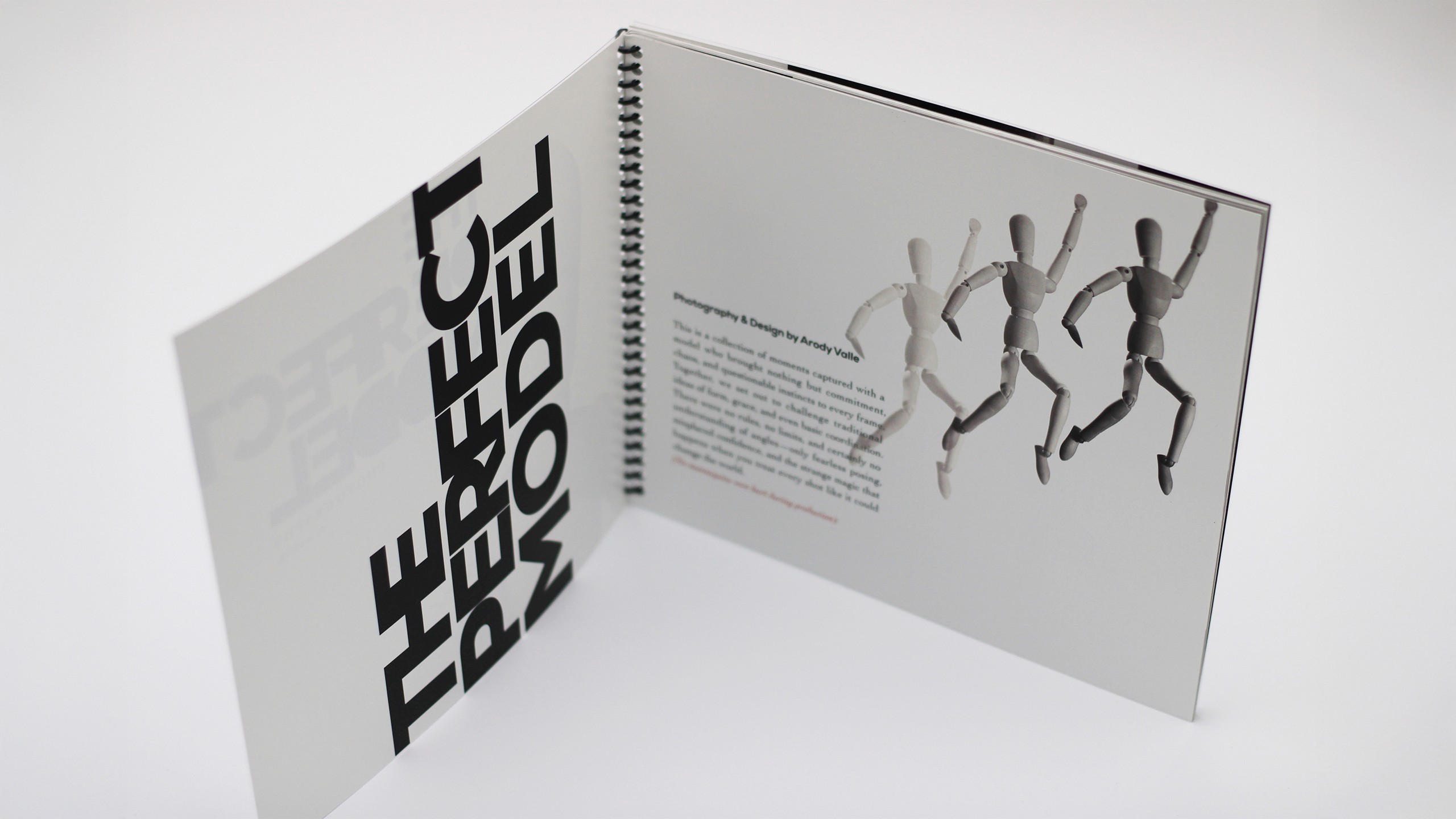 Black and white photo of a drqwing mannequin jumpring across the spread of the book. There are transparency shadows of the subject showcasing its jumping movement.
