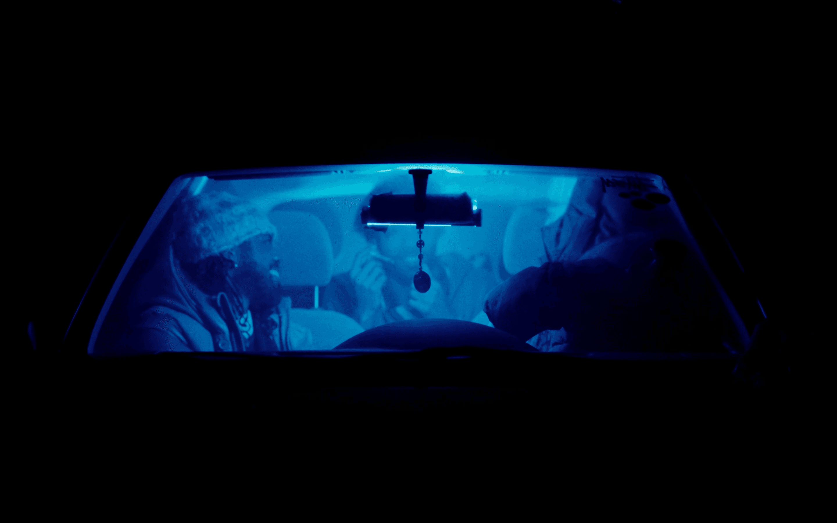 Silhouetted crowd observes pyramid through large windows.