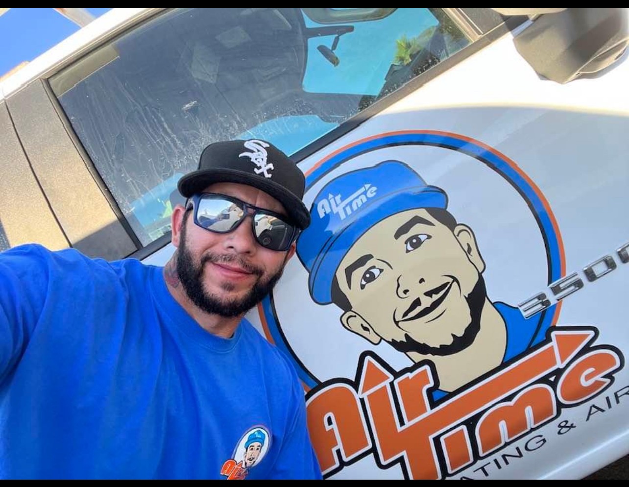 Owner of Air Time with a logo of his company next to him