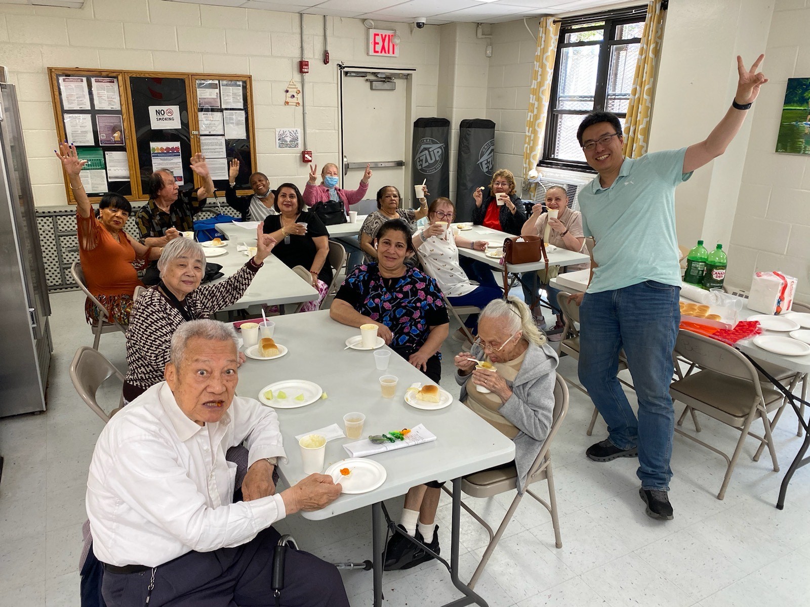 Older adults at lunch pose with a nutritionist.